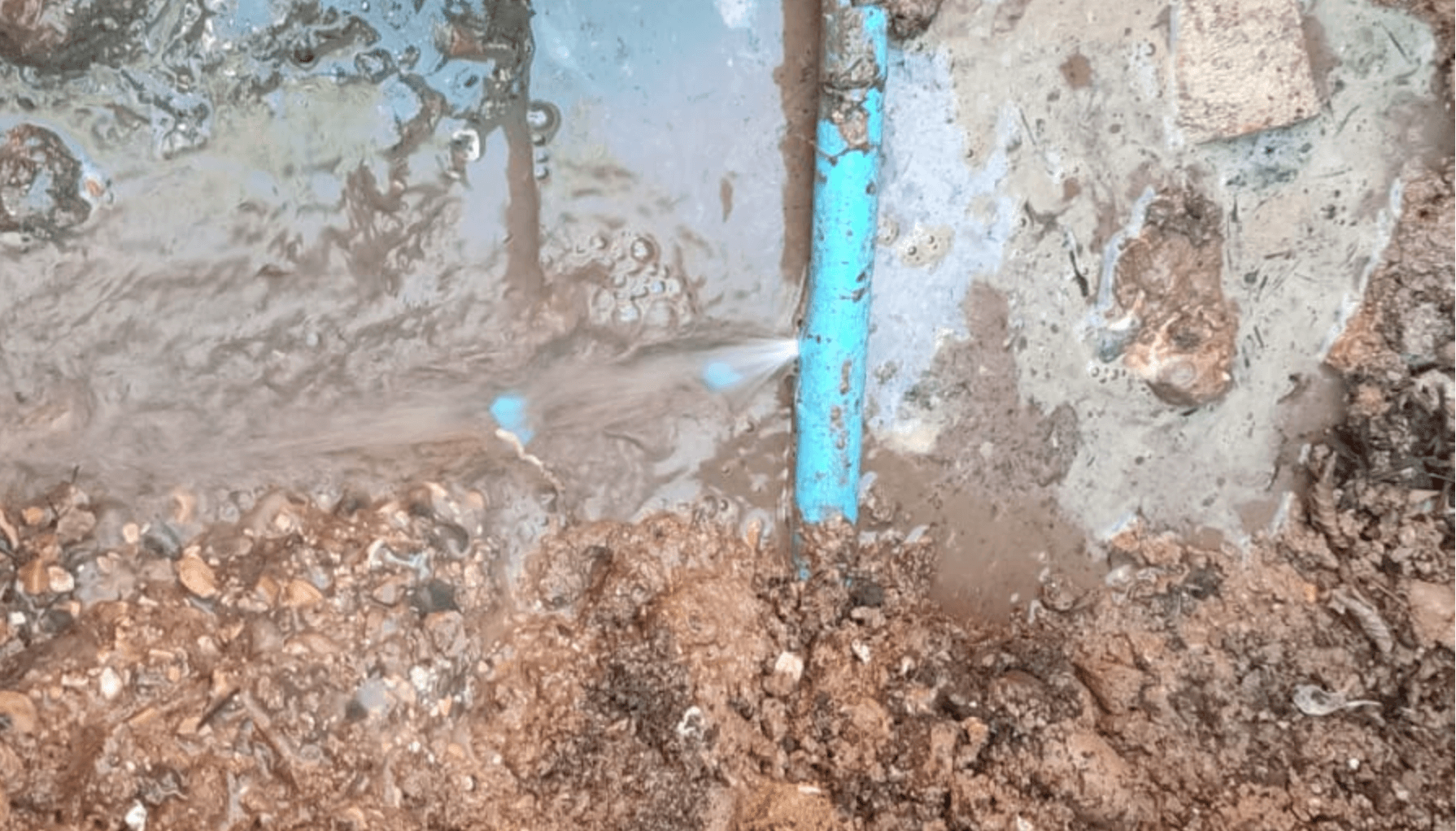 Underground water pipe leak causing pooling and soil saturation